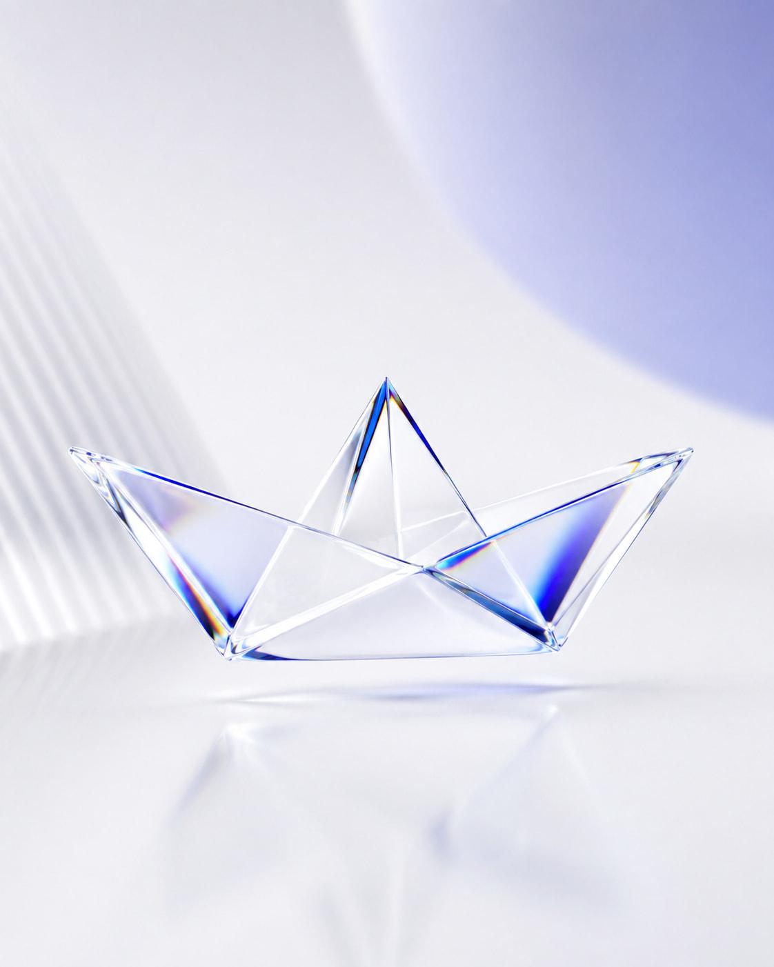 A paper boat folded out of clear glass, every face splitting the light into a different colour.